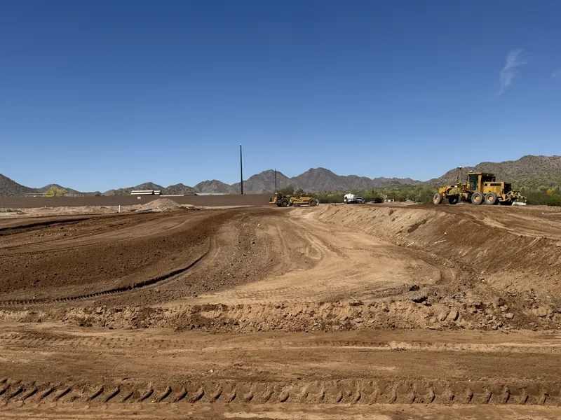 Heavy equipment site development grading in desert terrain